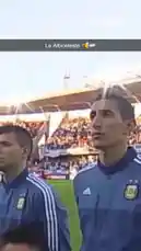 A behind-the-scenes look at Argentina's national football team walking out onto the pitch during the CONMEBOL Copa América 2024 tournament. Players in their official blue training jackets, featuring the AFA crest and Adidas branding, make their way across the field under bright stadium lights, with fans filling the stands in the background. by @copaamerica with Original Sound by copaamerica