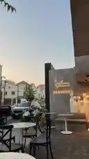 This video offers a serene, real-time look inside Sequence Coffee, showcasing its stylish outdoor seating, modern branding, and inviting ambiance during golden hour. Viewers see the café's unique architectural details, including its illuminated logo and artistic sculptures, set against a backdrop of a quiet street with passing cars and nearby buildings. The calm atmosphere highlights the café as a contemporary urban retreat perfect for coffee lovers and those seeking a peaceful spot to relax. by @sequence-coffee with original sound