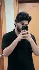 In this mirror selfie, D SUN 🇦🇪🇮🇳 captures his look in a simple black shirt and styled dark curls. The casual moment offers insight into his personal style, making it perfect for fans curious about his everyday aesthetic. by @dsunmusic with original sound