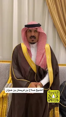 This video features Khaleefa Eid, dressed in traditional Saudi clothing including a brown thobe with gold trim, a red-and-white checkered ghutra secured by a black agal, and a white shirt. He is seated in a formal setting with ornate golden chairs and curtains, speaking directly to the camera. His attire and demeanor reflect cultural pride and formality. by @kh-p19 with kh-p19 by Original Sound