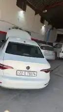 Experience the behind-the-scenes of Wasta Hawkar Auto Service, a bustling car repair garage. This walkthrough reveals a white sedan, a silver SUV, and various service equipment in a well-lit, spacious workshop, offering insight into professional vehicle maintenance. by @hawkar_service with original sound