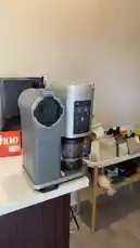 This close-up shot captures a sleek Ninja coffee maker actively brewing coffee. The machine's digital display is illuminated, showcasing its modern design and functionality. The sound of the coffee maker operating can be heard, providing a realistic auditory experience. by @alysf90 with Original Sound by alysf90