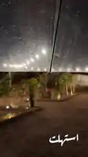 Experience a serene night stroll through a softly lit garden during a gentle rain shower. Viewed from under a transparent umbrella, the falling droplets create a mesmerizing pattern against the warm, glowing lights strung above. This peaceful moment captures the beauty of a quiet evening, perfect for relaxation and reflection. by @karim.alsaleh with karim.alsaleh by Original Sound