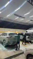 This nighttime tour takes you inside مغسلة أربع قطرات للسيارات, a modern car wash facility in Qatar. Watch as staff meticulously clean vehicles under bright lights, with some cars elevated on lifts. The scene captures the professional atmosphere and scale of this high-end auto detailing service. by @wash.4drops with Original Sound by wash.4drops