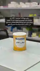 A close-up shot of a can of Novalac Colina Nova infant formula is displayed on a clean, white countertop in what appears to be a pharmacy or store. An Arabic text overlay provides key details: 'Novalac Colina Nova 400g', '12 weeks old and above', 'High protein content', and 'Available in pharmacies and stores'. The price is clearly marked as '61.95 EGP'. The visual is static, focusing on product information and pricing. by @bigmark.co with original sound