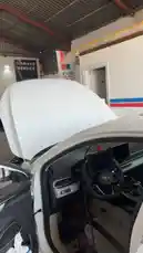 A quick look inside Wasta Hawkar service, showing a white car with its hood open in a busy workshop environment. by @hawkar_service with Original Sound by hawkar_service