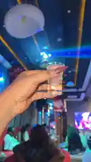Watch Big Erima shine in a vibrant nightlife setting, holding a stylish cocktail under colorful lights. This energetic scene captures a glamorous night out perfect for fans looking for lifestyle inspiration. by @eboggar1 with original sound