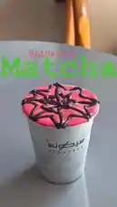 A close-up shot of a vibrant pink matcha latte from Sequence Coffee, topped with intricate chocolate drizzle art resembling a spiderweb. The text 'Spidermen Matcha' is overlaid on the screen, highlighting the unique design. by @sequence-coffee with ⊹₊⟡⋆`♡´⊹₊⟡⋆ by ᡣ𐭩    ᡣ𐭩    ᡣ𐭩