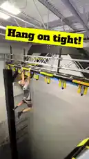 In this intense clip, fitness enthusiast Winchumbo attempts to power through a series of hanging monkey bars in an indoor obstacle course. With a motivational 'Hang on tight!' text overlay, he demonstrates strength and determination before losing his grip and landing safely on the padded mat below. This action-packed moment captures the thrill and physicality of modern obstacle training. by @winchumbo with Original Sound by winchumbo