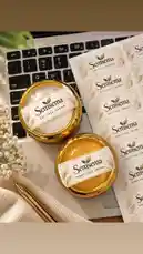 A top-down view showcases Semsema's herbal day and night face creams, presented in elegant gold pots alongside branded labels on a laptop keyboard. This aesthetic setup highlights the product packaging and branding, suggesting a professional review or promotional content for the skincare line. by @semsemallc25 with احلي منهم by ايهاب توفيق