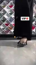 A person models a stylish black abaya adorned with sparkling crystal embellishments on the sleeves. They showcase the garment's elegant design before holding up a white paper shopping bag from 'Khal's baba'. The background features a colorful, geometric shelving unit, suggesting a boutique setting. by @mohammed_aldrop with Original Sound by Contains: BonBon Attan Song | آهنگ ترند جدید مراکش بن بن اتن - Setara Tones