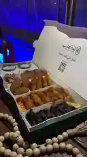 Experience the delicious spread from Lazza Aneb, featuring their signature grilled chicken tawook, savory sambousek, and other traditional delights. This appetizing platter is presented in their branded packaging, showcasing a perfect meal option. by @la_ea10 with Original Sound by la_ea10