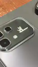 This close-up shot reveals a smartphone's camera module featuring a unique pixel art design. The image focuses on the camera lenses and the distinctive illuminated pattern, showcasing a creative detail often found on modern devices. by @point_tech1 with Original Sound by point_tech1