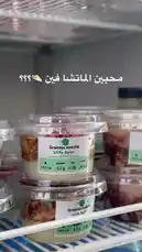 A close-up view of protein-packed granola matcha cups neatly arranged on a refrigerator shelf. The labels clearly display nutritional information like calories, protein, fat, and carbs, highlighting their suitability as a convenient and healthy meal or snack option. by @proteinz_sa with original sound