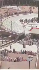 This video captures a vast crowd of worshippers gathered at the Grand Mosque for prayer. The camera pans across the expansive courtyard, showing people dressed in traditional white garments arranged in neat rows, all facing the Kaaba. The atmosphere is one of solemnity and devotion as the congregation participates in a collective act of worship. by @yothaim with Original Sound by yothaim