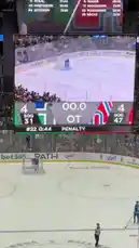In this intense hockey game moment captured by Sasha, the scoreboard shows a tied 4-4 game between the Hurricanes and Avalanche during overtime. Players are on the ice under bright arena lights, with one player preparing for a penalty shot. The large jumbotron displays team statistics, player names like Staal and Makar, and the live action from a high-angle view. Fans fill the stands, creating a charged atmosphere as the game hangs in the balance. by @squashha with squashha by Original Sound