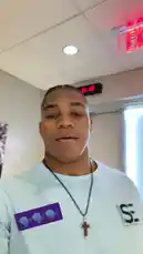 A player from the Minnesota Vikings is featured in this short clip, reacting to a viral sound effect. He is seen in a light blue shirt with a cross necklace, standing indoors near an exit sign. The audio consists of a deep, guttural growl, suggesting he is responding to a popular meme or prank. by @vikings with Original Sound by vikings