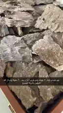 This close-up exploration reveals the intricate textures and natural beauty of raw agarwood chips stored within an elegant wooden box. Watch as the camera pans across these valuable pieces, highlighting their unique patterns and rich coloration. by @nawader.aloud44 with original sound