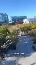 tufavlatiino 님이 만든 Original Sound 포함 @tufavlatiino 님이 만든 This high-angle footage captures the serene atmosphere of Google's MP1 campus in Sunnyvale, CA. The camera glides over modern glass office buildings, lush green lawns, and trees displaying vibrant autumn colors under a clear blue sky. The scene highlights the company's expansive outdoor spaces, including walking paths and seating areas, offering a glimpse into its contemporary work environment.