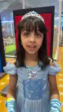 A young girl dressed as Cinderella excitedly interacts with a man in traditional Middle Eastern attire, possibly a sheikh, inside a colorful indoor play area. The playful moment is accompanied by Arabic music and speech, capturing a lighthearted cultural exchange. by @gioco_23 with Original Sound by gioco_23