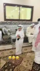 In a beautifully appointed room, a group of men dressed in traditional white thobes and ghutras engage in a formal gathering. One man, identified as Faisal Al-Suhail, stands and interacts with others seated on an ornate sofa. The atmosphere is one of respect and tradition. A key moment occurs when a man hands over a wad of currency notes to another, who then smiles broadly before placing the money into his robe pocket. This act, captured in close-up, highlights a significant cultural exchange, possibly a gift or a transaction, within a setting of honor and formality. by @snap_alshle with Original Sound by snap_alshle