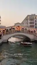 Experience a tranquil journey along the picturesque canals of Venice during golden hour. A sleek red and white speedboat glides smoothly beneath charming arched bridges, passing elegant buildings adorned with balconies and vibrant green awnings. This serene tour captures the timeless beauty of Venetian architecture and waterways, offering a peaceful escape into one of Italy's most iconic destinations. by @azozi.5562 with Original Sound by azozi.5562