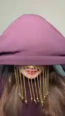 In this captivating lookbook-style video, Rawan Naser showcases her artistic transformation into a traditional cultural aesthetic. She begins with a dramatic reveal, unveiling a face adorned with intricate gold chains and coins, covering her eyes and mouth. Dressed in a deep purple hijab, she then demonstrates different headscarf styles, including one with vibrant floral patterns, highlighting the versatility and beauty of these traditional accessories. The video includes a brief clip from a news article about the 'hijab' and features Arabic text, suggesting a focus on cultural identity and fashion. by @mediarawan with mediarawan by Original Sound