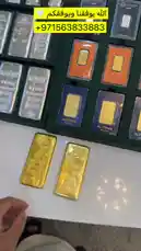 A close-up tour of a collection of precious metal bullion bars, including a prominent 1-kilo Swiss gold bar and various silver bars. A hand picks up and displays the items, showing their details and packaging against a backdrop of organized display trays. by @th4eb with Original Sound by th4eb