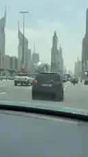 Experience a first-person perspective of driving through the bustling streets of Dubai, passing by its world-famous skyline filled with towering skyscrapers. This immersive view captures the city's modern architecture, busy traffic flow, and urban energy, showcasing landmarks like The Tower and Emirates Towers. by @dsunmusic with original sound