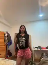 In a personal bedroom setting, Garwang performs a casual dance routine. Dressed in a black graphic t-shirt and pink patterned shorts, they execute simple, rhythmic movements, including hand gestures and body sways. The unscripted, home-recorded feel suggests a fun, informal practice session. by @gar_wang with Original Sound by Contains: CHANEL - Tyla