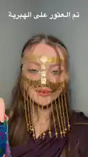 This step-by-step tutorial showcases a woman demonstrating how to style a traditional gold coin face mask and a vibrant purple floral headscarf. She begins by displaying the accessories, then carefully wraps the scarf around her head and adjusts the ornate mask over her eyes and nose. Finally, she drapes a dark purple hijab over her shoulders, completing the elegant and culturally-inspired look. by @mediarawan with mediarawan by Original Sound