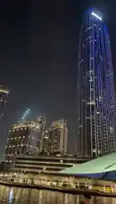 Experience the magic of Dubai Marina at night with this stunning point-of-view cruise. The camera glides past iconic luxury hotels illuminated in vibrant blue, offering breathtaking reflections on the water. See the city's dazzling skyline, including the Burj Khalifa, before arriving at a waterfront oasis spot with a glowing 'OASIS SEA' sign and a UAE flag fluttering in the breeze. by @moazzam with Original Sound by moazzam