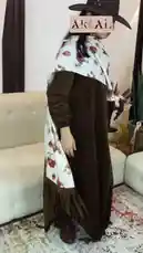 A model showcases a long brown dress from Artal Fashion. She turns to display the full length of the dress and its unique white top layer with a camel print and fringe details. by @artal.street with artal.street by Original Sound