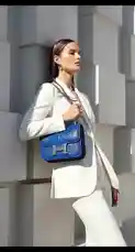 This stylish montage presents a curated collection of luxury items, perfect for fashion enthusiasts. It features a model showcasing a chic white suit and a vibrant blue crocodile Hermès bag against a modern architectural backdrop. The sequence then transitions to highlight exquisite accessories, including a Cartier bracelet, a Rolex watch worn on a wrist, and a classic Gucci handbag displayed with a croissant. The video culminates in a close-up of the Gucci bag with the text 'the 4EEB For luxury products BUY NOW,' clearly promoting the 4EEB STORE. This visually rich compilation emphasizes high-end fashion, timeless jewelry, and sophisticated lifestyle branding. by @th4eb with Original Sound by th4eb