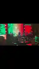 Experience the energy of a live music performance at 'the villa'. This scene captures a band playing on stage under dynamic red and green lights, with confetti filling the air as an enthusiastic crowd enjoys the show from their tables. by @managergxcci with Original Sound by managergxcci