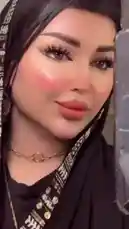 A close-up showcase of Bella Klinkin's elegant style, featuring her black hijab with a distinctive gold and white patterned border, complemented by a sleek black top, a delicate gold chain necklace, and large hoop earrings. Her polished makeup, highlighted by bold winged eyeliner and a soft peach blush, completes the look. by @bellaclinickw with Original Sound by bellaclinickw