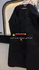 A stylish black abaya with intricate floral beadwork is displayed on a hanger. The camera pans across the garment, highlighting its beautiful details and texture. by @mohammed_aldrop with ❤️❤️❤️❤️❤️❤️😔 by U