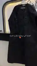 A stylish black abaya with intricate floral beadwork and embroidery is displayed on a hanger. The garment features a modern design with traditional elements, highlighting its elegance and craftsmanship. by @mohammed_aldrop with Original Sound by mohammed_aldrop
