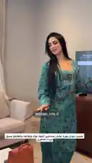 Watch WEDAD| وداد المنهالي showcase her elegant style and confident presence in this captivating clip. She wears a beautiful teal patterned dress and a long gold necklace, gracefully handling a traditional cane-like prop. The setting appears to be a modern living room with a TV in the background. This video highlights her poise and fashion sense. by @wedad_23g with Original Sound by wedad_23g