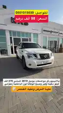 A comprehensive walkthrough of a pristine white 2019 Nissan Patrol Platinum V8 SUV, showcasing its exterior design, luxurious tan leather interior, and key features like the V8 badge and infotainment system. The vehicle is presented as being for sale in Saudi Arabia, with contact information displayed. by @aaaaaa with Original Sound by aaaaaa