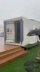 In this vlog, a woman braves a rainy day to explore a modern, compact living space. She enters the futuristic white pod, showcasing its sleek interior design, which includes a kitchenette, a spacious bathroom with a walk-in shower, and a cozy bedroom area. The tour highlights the efficient use of space and contemporary features like smart lighting and large windows, offering a glimpse into innovative urban living solutions. by @maddi_op with maddi_op by Original Sound