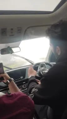 This immersive, first-person perspective captures a journey through thick fog while driving a modern car. The windshield wipers are actively clearing condensation and rain, highlighting the challenging visibility. The driver's hands are visible on the steering wheel, and the vehicle's dashboard features illuminated controls, providing a realistic look at navigating in poor weather. This raw, unedited footage offers a practical demonstration of driving safely in adverse conditions. by @amohammad_97 with amohammad_97 by Original Sound