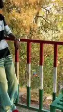 A young man leans casually against a railing at a train station, smiling as he checks his bank balance on his phone. The screen shows a mere ₹4.51, but his carefree attitude and the text overlay 'Sher ab 1 saal tak trip pe nahi jaega' (Sher won't go on a trip for another year) suggest he's unfazed. The audio features a dramatic voiceover asking, 'Kahan hai ji?' (Where is it?), adding to the comedic and relatable 'poor but happy' narrative. by @lil.ishhhh with Original Sound by lil.ishhhh
