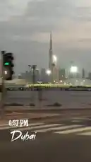 This cinematic clip captures the iconic Dubai skyline during the evening rush hour. The camera, seemingly from a moving vehicle, pans across bustling city streets before focusing on the majestic Burj Khalifa piercing the twilight sky. The scene is illuminated by streetlights and the warm glow of the setting sun, creating a dynamic and beautiful urban landscape. by @dsunmusic with Original Sound by dsunmusic
