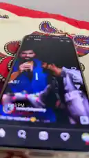 A smartphone screen displays a viral TikTok-style 'Reel' featuring Navneet. He's seen holding a microphone, smiling and laughing, seemingly during a lighthearted moment or performance. The casual, candid nature of the clip suggests it's a fun behind-the-scenes snippet or a comedic take. by @im.navnit with Original Sound by im.navnit