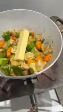 Watch as Dr. Turki Al-Afasi demonstrates the initial steps of preparing a delicious vegetable biryani. This close-up cooking tutorial shows diced vegetables like carrots and zucchini being seasoned and placed in a pan with butter over medium heat. The speaker narrates in Arabic, explaining the process of sautéing the ingredients before adding rice to create a royal-style biryani. A perfect guide for home cooks looking to master this aromatic dish. by @alafasy81 with Original Sound by alafasy81