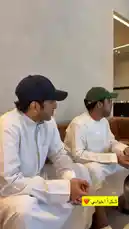 In a heartwarming celebration captured on video, Mohammed Al Omair is surprised by his friends during a gathering in a modern lounge. Dressed in traditional white thobes and caps, the group shares joyful moments as a server presents a beautifully decorated birthday cake with 'Happy Birthday Mohamed' written in chocolate. The atmosphere is festive and filled with laughter, capturing the essence of camaraderie and celebration. by @bbbbb with Original Sound by bbbbb