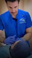 In this Bella Clinic video, Dr. Fouad Najjar discusses and performs a cosmetic procedure for men, focusing on forehead fillers. He explains the treatment's benefits, including correcting asymmetry and smoothing lines, while demonstrating the technique on a patient. by @bellaclinickw with Original Sound by bellaclinickw