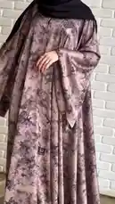 This video features Mohammed in a beautifully patterned Khial Abaya, a long, flowing garment often associated with modest fashion. He presents the abaya from various angles, highlighting its elegant design and fabric. The setting includes a modern room with a white brick wall and a distinctive poster, creating a stylish backdrop. The overall presentation emphasizes the aesthetic appeal and quality of the clothing. by @mohammed_aldrop with Original Sound by mohammed_aldrop