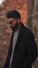Watch Moazzam Ishaq stride confidently through the weathered stone arches of an ancient ruin. Dressed in a sleek black coat over a light shirt and wearing stylish aviator sunglasses, he embodies modern elegance against a backdrop of historical grandeur. The warm, golden-hour light casts long shadows, highlighting his silhouette and the rugged texture of the old walls, creating a powerful and cinematic atmosphere. by @moazzam with Original Sound by moazzam